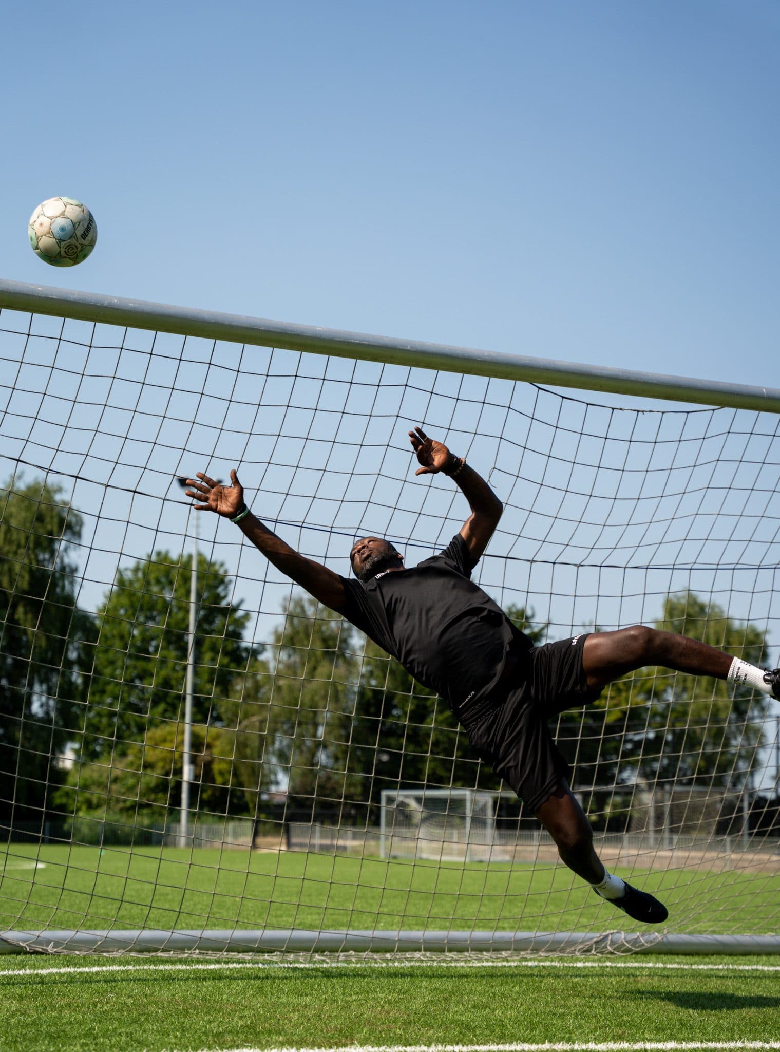 Goalkeeper mid-air in a diving save