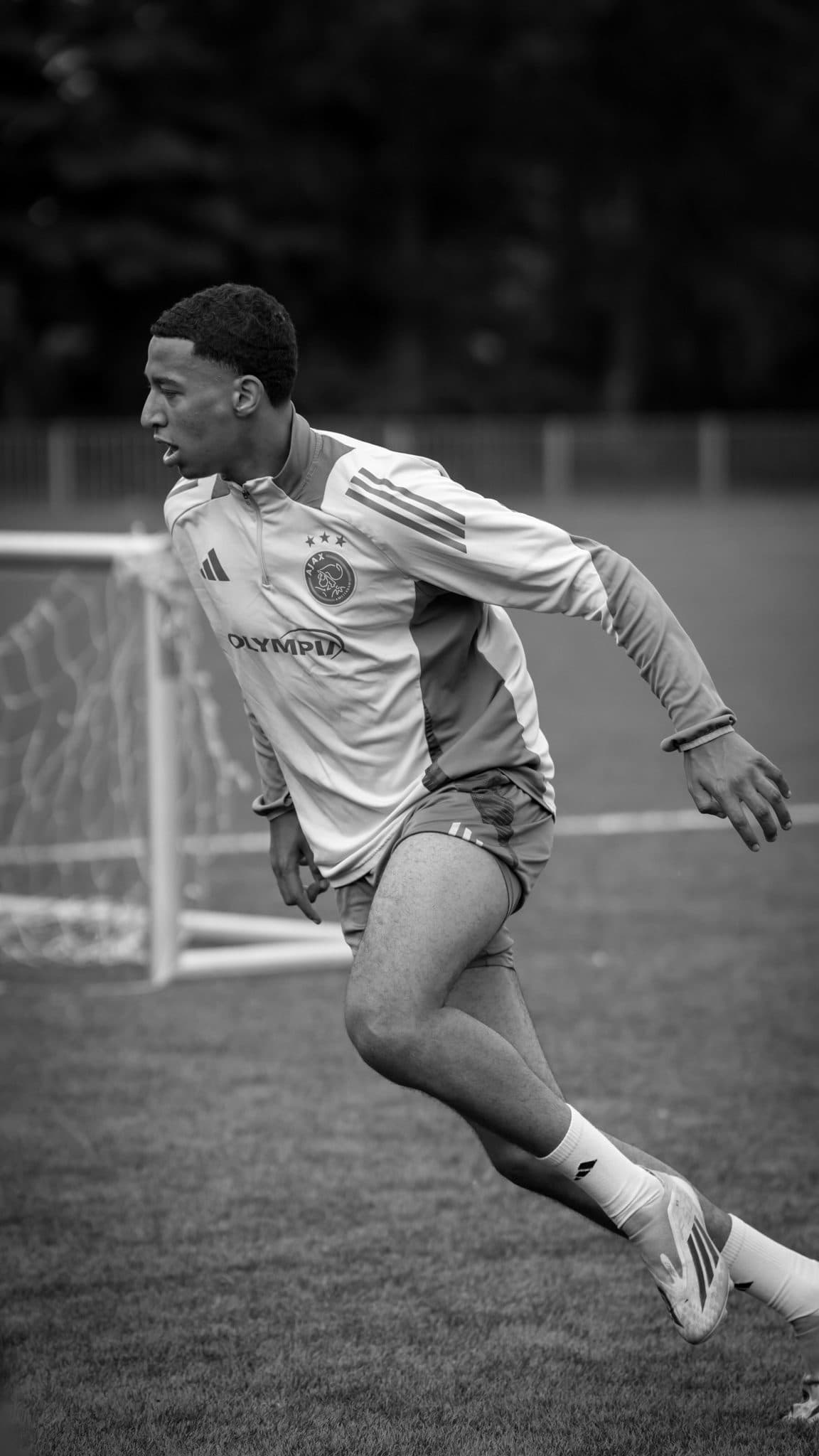Black and white shot of a player sprinting in training