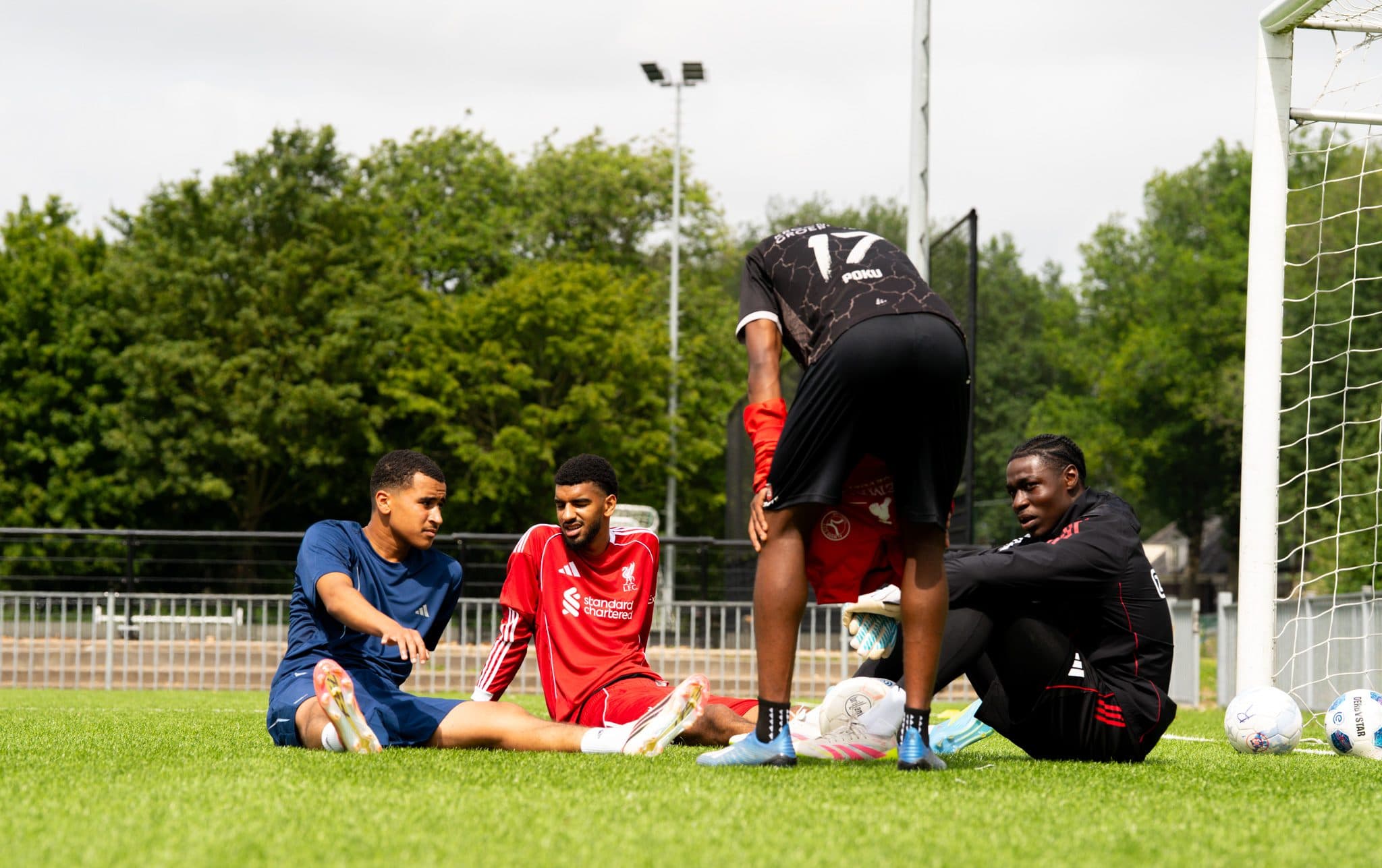 Players sitting together on the pitch between drills